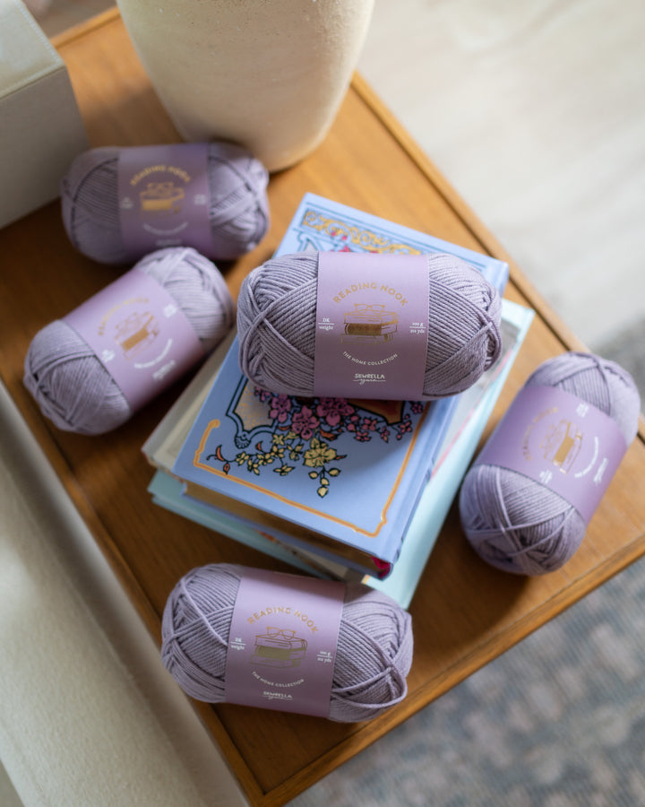light purple wool yarn on a wooden table