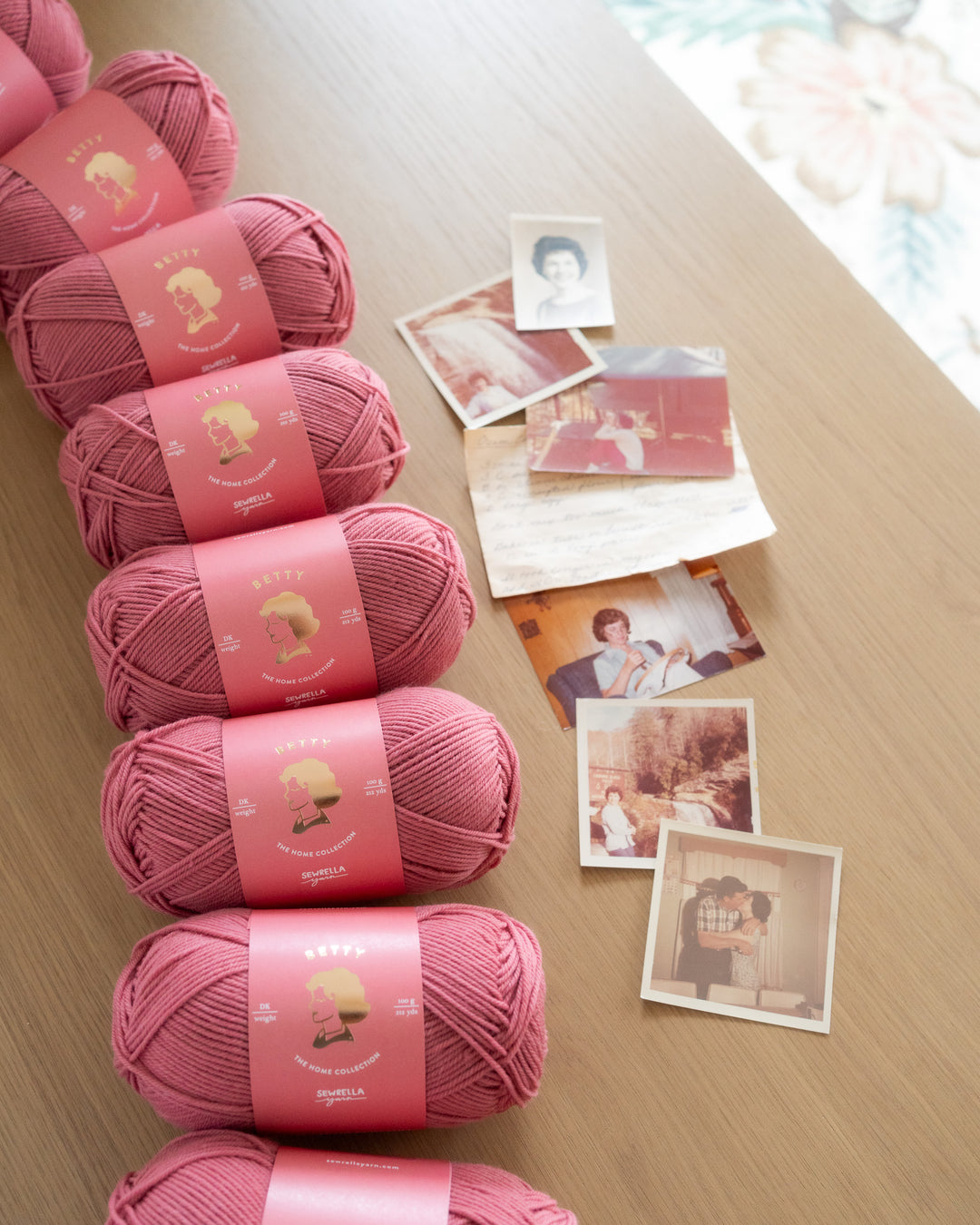 Rose pink 4 ply wool yarn on a wooden table