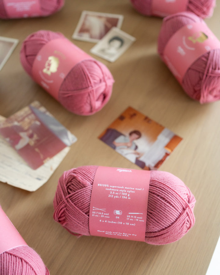 Close up of rose pink yarn showing the matte finish of superwash merino wool